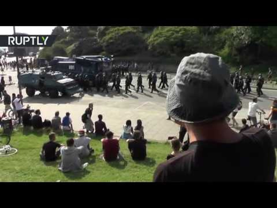 Anti G20 protester whistles Star Wars Imperial March as police patrol Hamburg streets