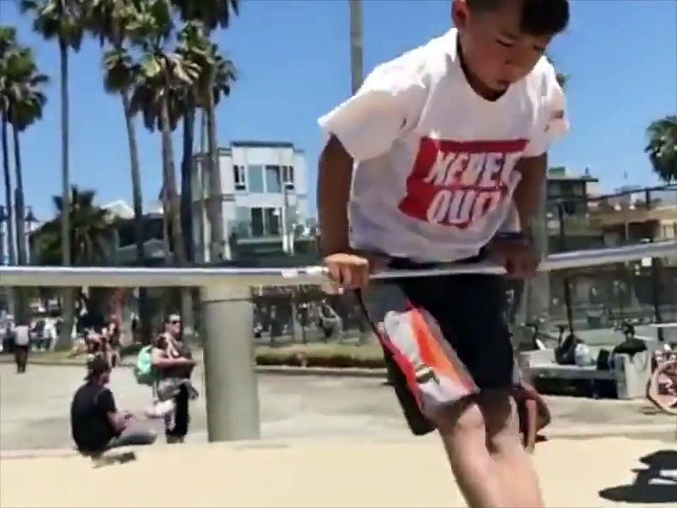 Small boy practising gymnastics in field