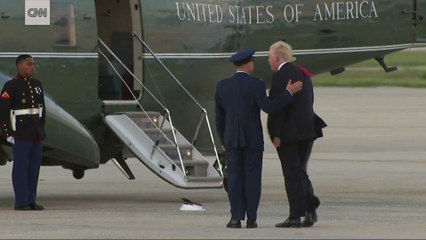 Trump stops to pick up a Marine's hat that was blown off by the wind. (07-08-2017)