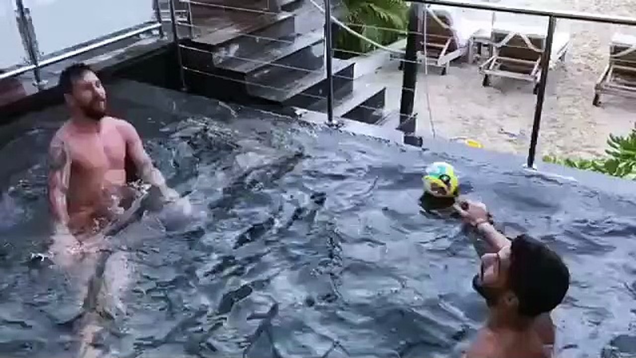 Messi and Suarez playing in the pool