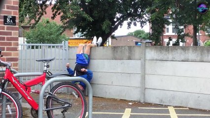 Pensioner exercising hanging upside down from a WALL