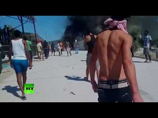 Download Video: ‘Out of control’: Protesters set fire in Greek refugee camp