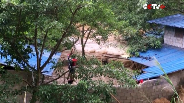 Firefighters use crane to rescue men trapped by by flood