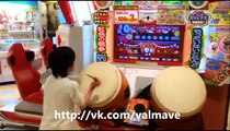 Japanese kid playing on Taiko drums in arcade