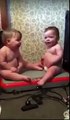 Babies sit on vibrating keep fit machine