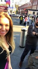 Girl tickling beard of man on the streets of London