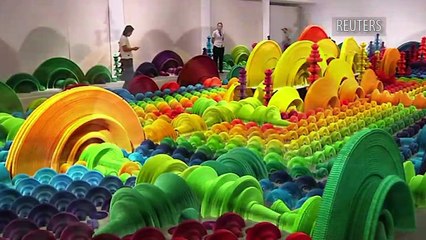 Chinese artist makes colorful paper guns that turn to flowers