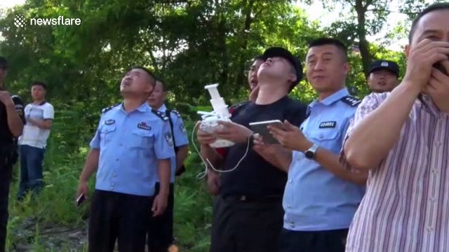 Rescue team use drone to deliver life belts to stranded anglers in China