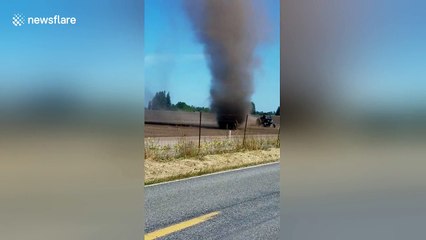 Huge dust devil swirls across field