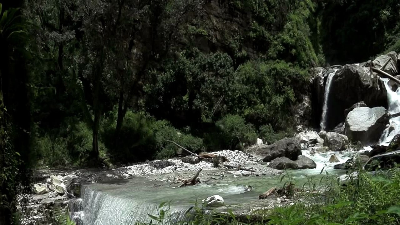 Crossing a raging Himalayan torrent by car- monsoon in the mountains