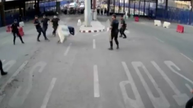 Spanish police throw traffic barrier at knife-wielding man