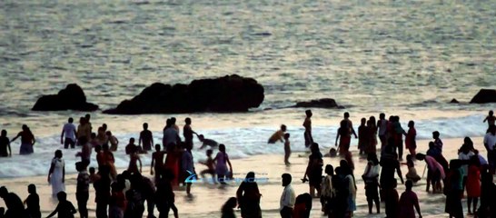 Tourists cluster on shore of Rama Krishna Beach in Andhra Pradesh