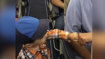 2-year-old fist-bumps airplane passengers