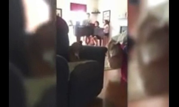 Dog Sings Along With Family Playing Piano