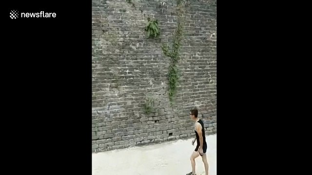Real-life Spiderman climbs vertical brick wall