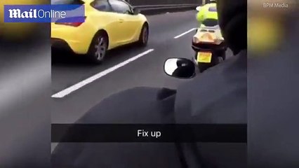 Biker films him SMACK officer's helmet as they race past