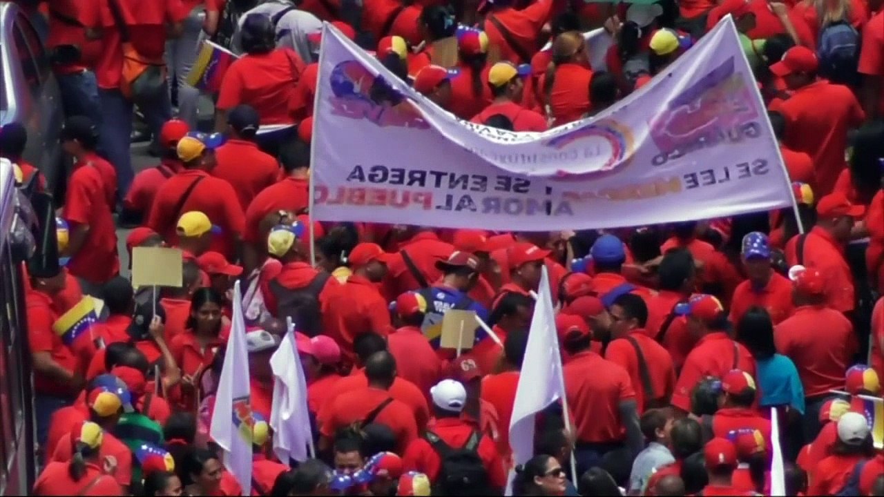 Pro-government activists march through Venezuelan capital