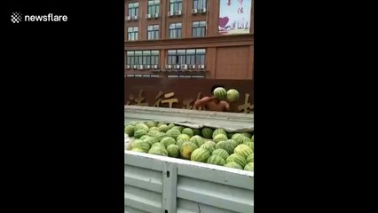 Vendor smashes watermelons outside local government office