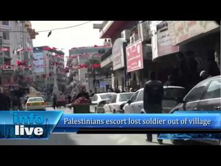 Palestinians escort lost soldier out of village
