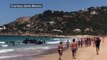 A boat full of migrants lands at a popular tourist beach in southern Spain - BBC News