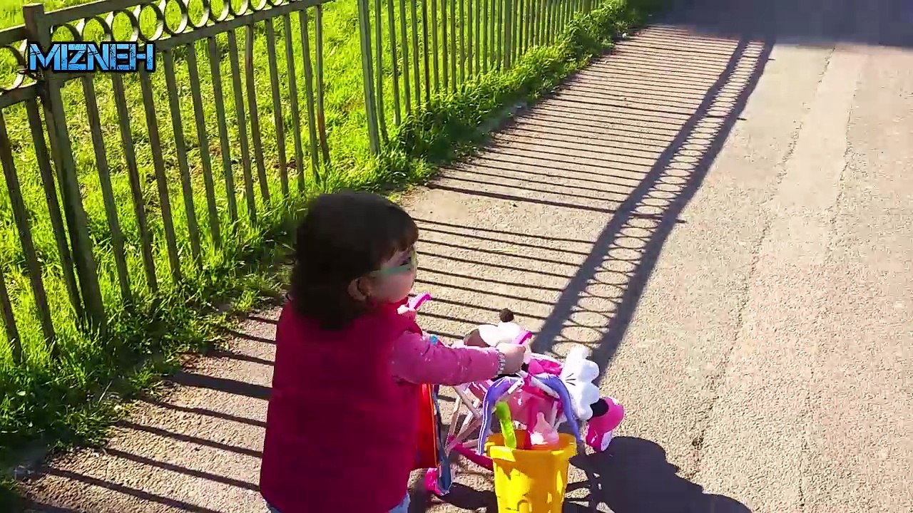 Baby taking her Minnie for a walk