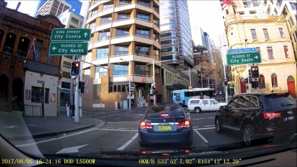 Pedestrians Walk in Front of Garbage Truck