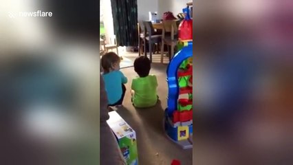 Adorable 2 year old comforts her twin brother