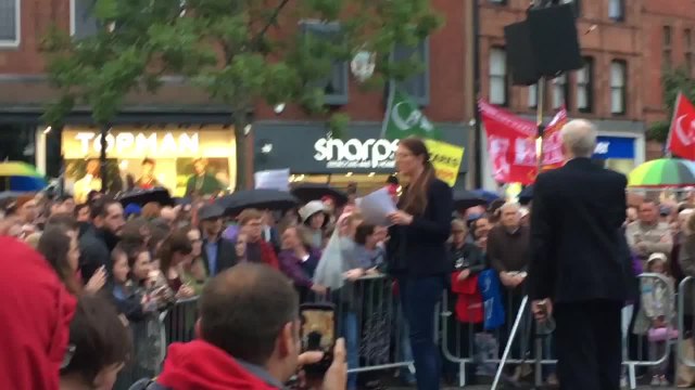 Corbyn Holds Umbrella For Labour MP