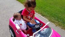 Little Girl and Silicone Baby on their first car /Pink Power Wheels Ride