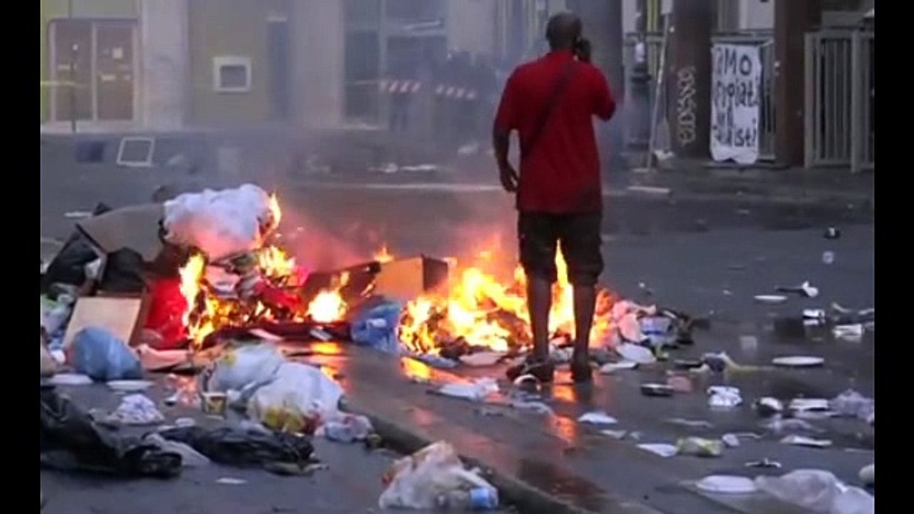 Defiant migrants throw rocks and bottles at riot police in Rome who turn on the water cannon to remove them from makeshi
