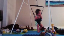 happy baby playing on jolly jumper