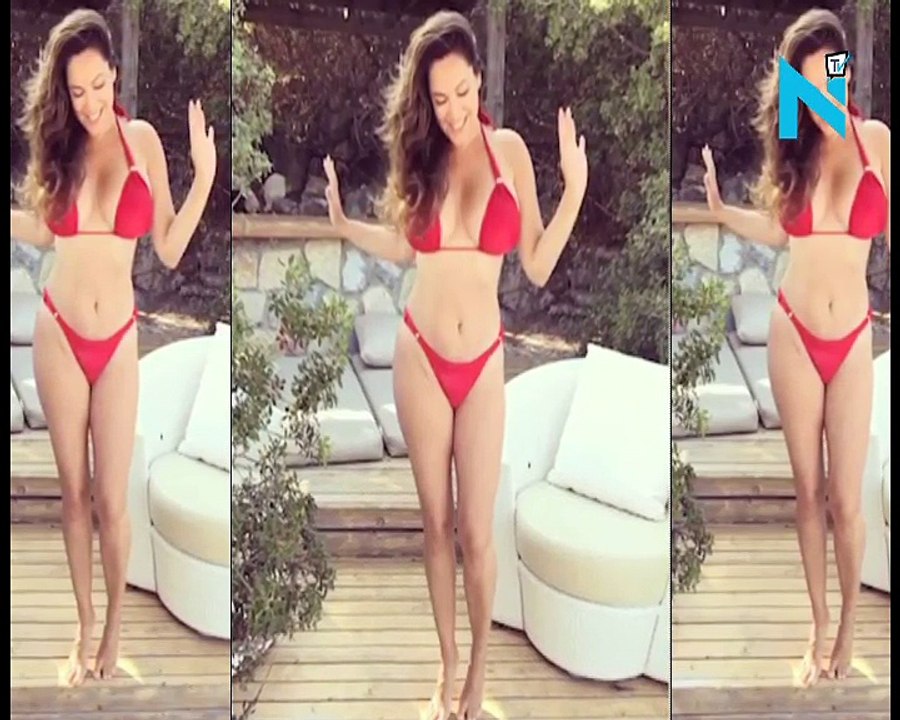 Kelly Brook showcases her ample assets and hourglass curves in a skimpy string bikini... after being bodyshamed by cruel