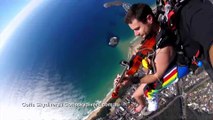 Naked skydiving musician plays violin during jump