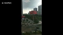 Typhoon downs huge billboard smashing vehicles