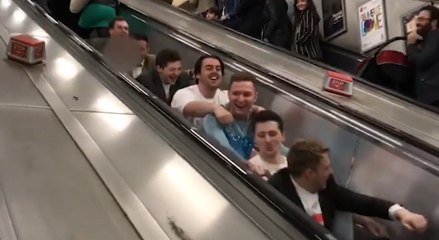 Guys Pretend To Row Up Escalator