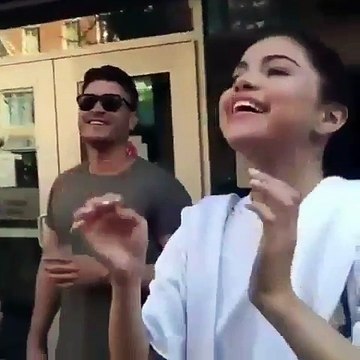 Selena Gomez putting her glasses on a little fan and taking photos