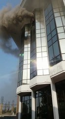 Police officials trying to rescue two men leaping from a building