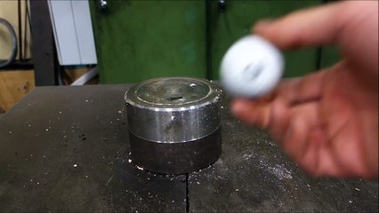 Crushing golf ball with hydraulic press