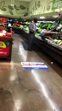 Une femme fait l'amour aux légumes dans le supermarché