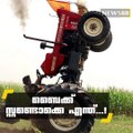 Daredevil farmer performs unbelievable tricks on his tractor including 300 foot wheelies