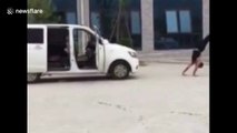 Kung fu master pulls minibus as he walks on his hands