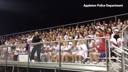 Cop pretends to stop a football fan party before dancing