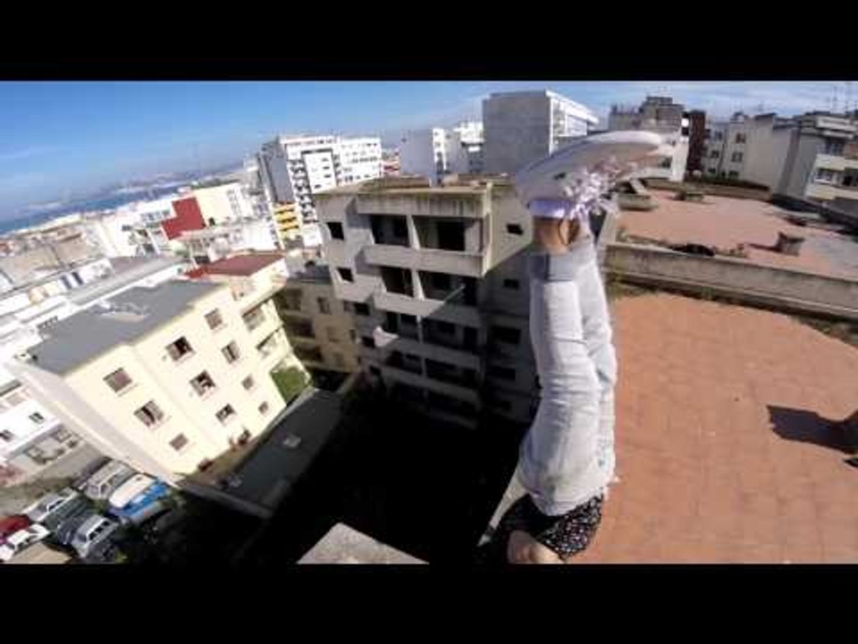 Fearless Thrill Seeker Balances On Roof Top