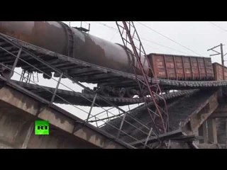 RAW: Train suspended over motorway as bridge blown up in E. Ukraine