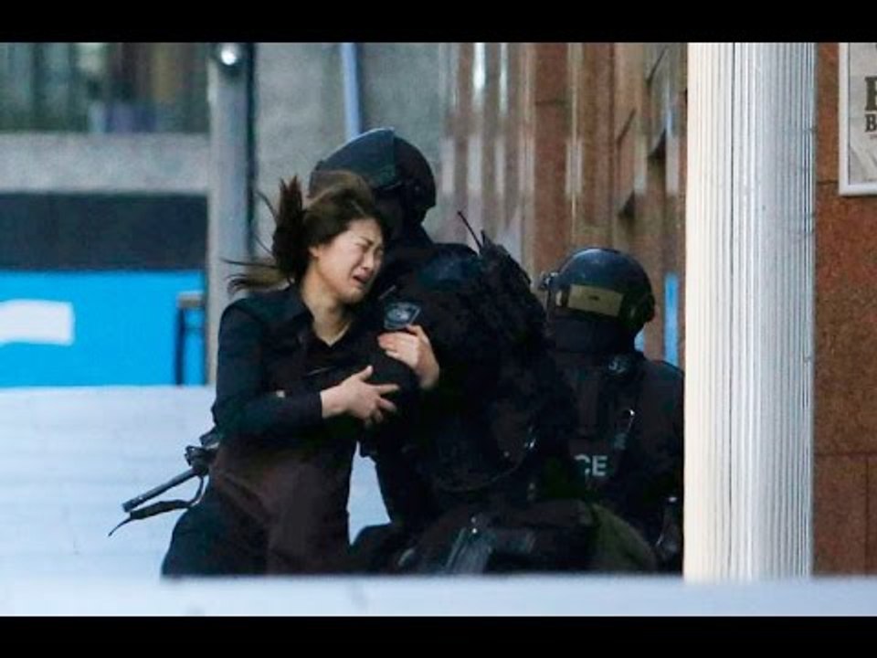 DRAMATIC: Sydney siege hostages run from Lindt Cafe, more remain trapped