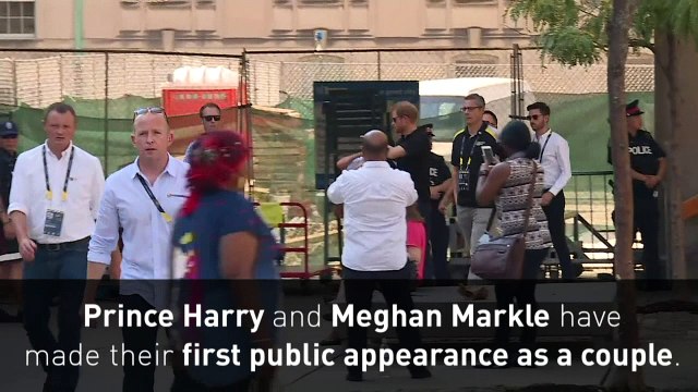 Prince Harry and Meghan Markle hold hands at Invictus