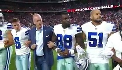 Dallas Cowboys owner Jerry Jones, players lock arms and kneel before national anthem as crowd boos