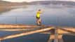 Daredevil Unicyclist Rides Along Narrow Girders of Steel-Frame Bridge