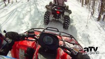 Arctic Cat & Yamaha ATVs blasting through the forest in the snow