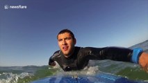 Curious seal plays with surfers in France